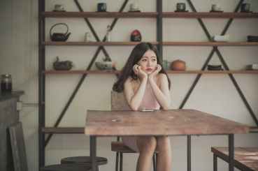 photography of a woman sitting on the chair listening to music
