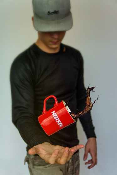 photo of man tossing nescafe mug