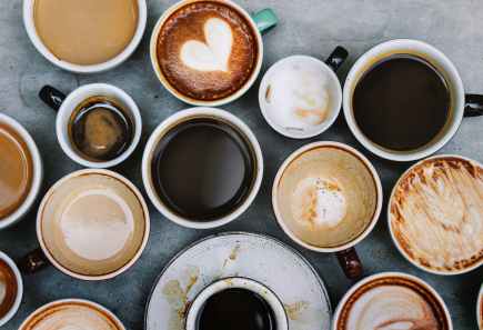 top view photo of ceramic mugs filled with coffees