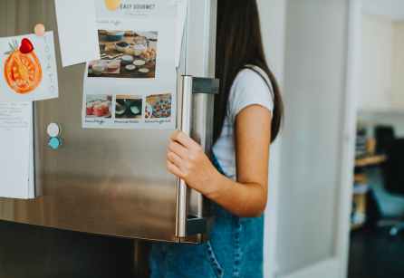woman opening refrigerator