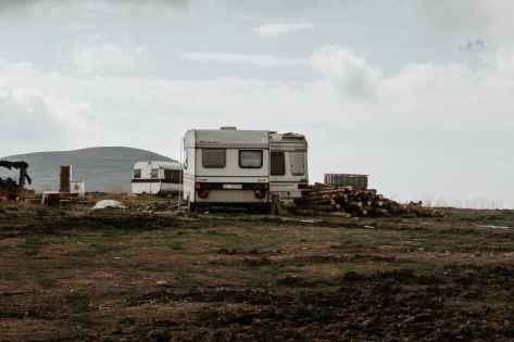gray camper trailer on grass field
