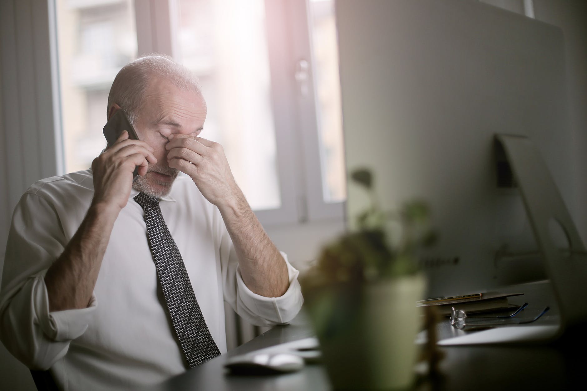 man using smartphone while sitting at the table