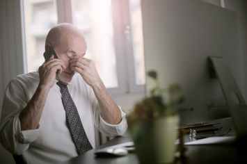 man using smartphone while sitting at the table