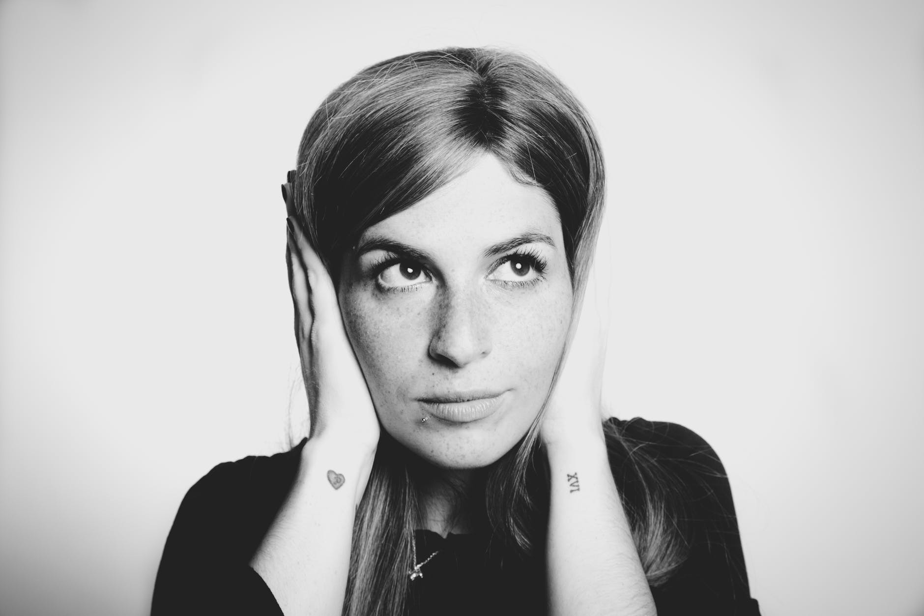 close up photo of woman covering her ears