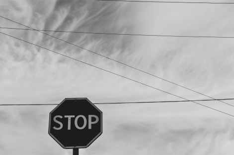 grayscale photography of stop signage under sky