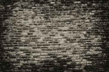 grayscale photo of brickwall