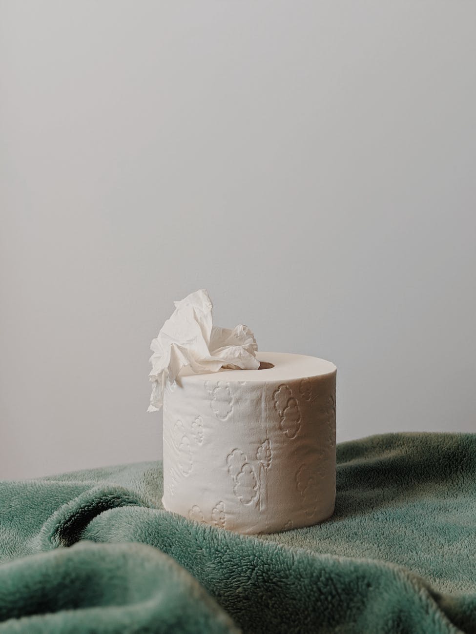 white tissue roll on green textile